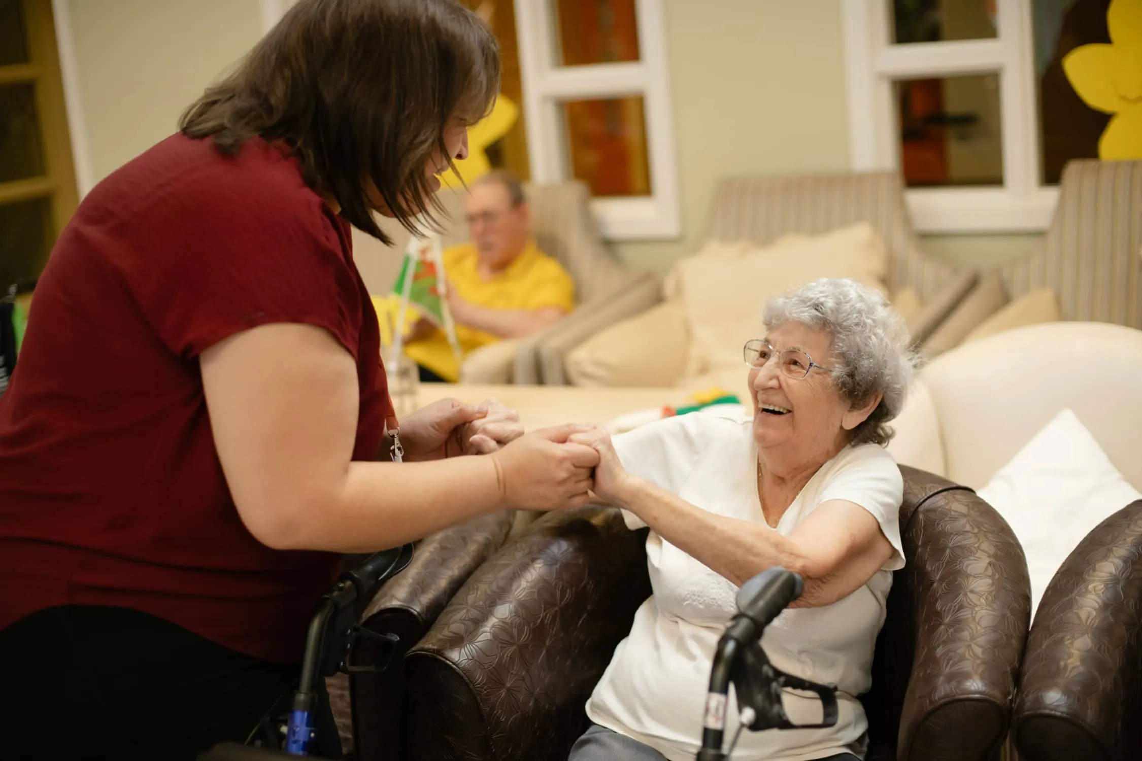 A caregiver and resident sharing a laugh